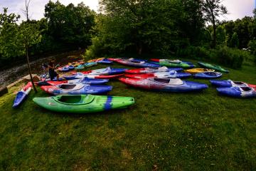 a group of lawn chairs sitting on top of a body of water